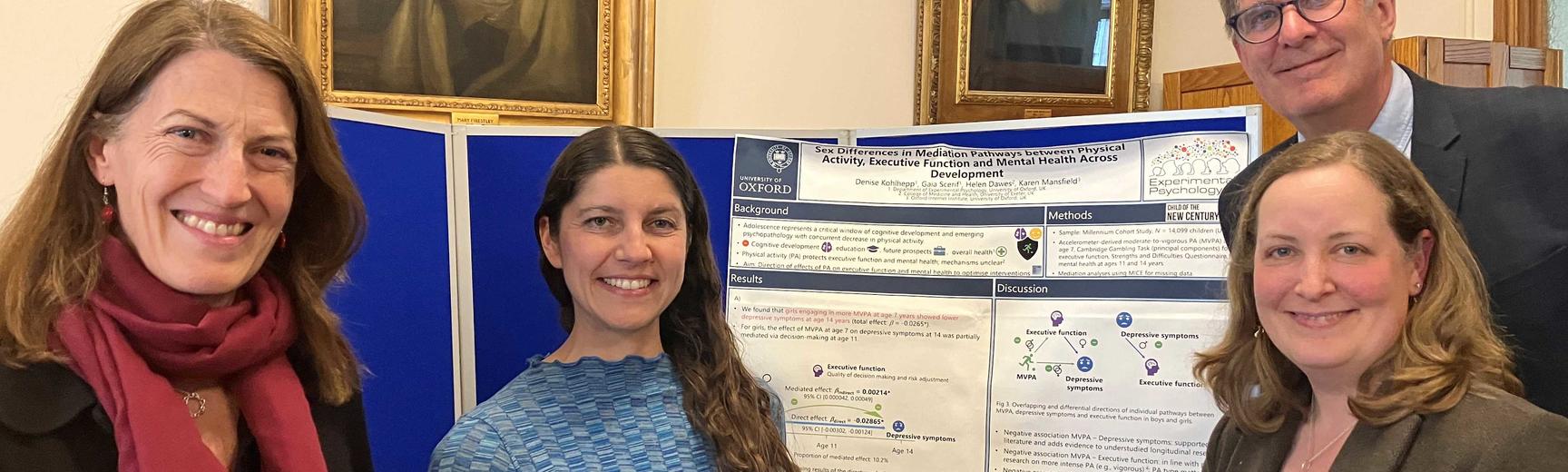 Denise Kohlepp in front of her poster with Beth Breeze, Rob Klassen and Bethany Sollereder
