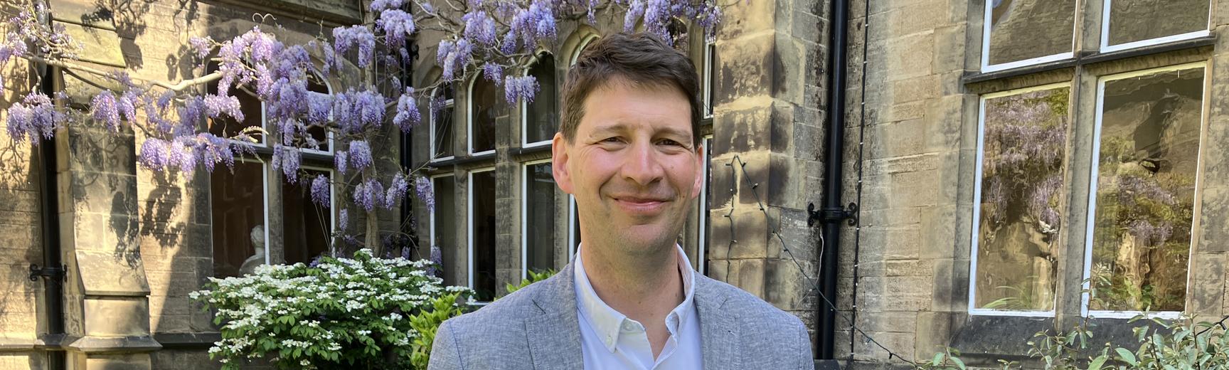 Professor Joshua Hordern holding book