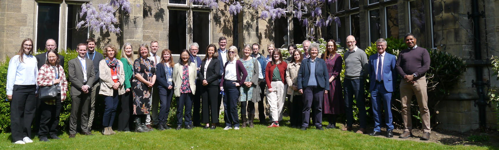 Doctors and teachers roundtable group photo in college quad