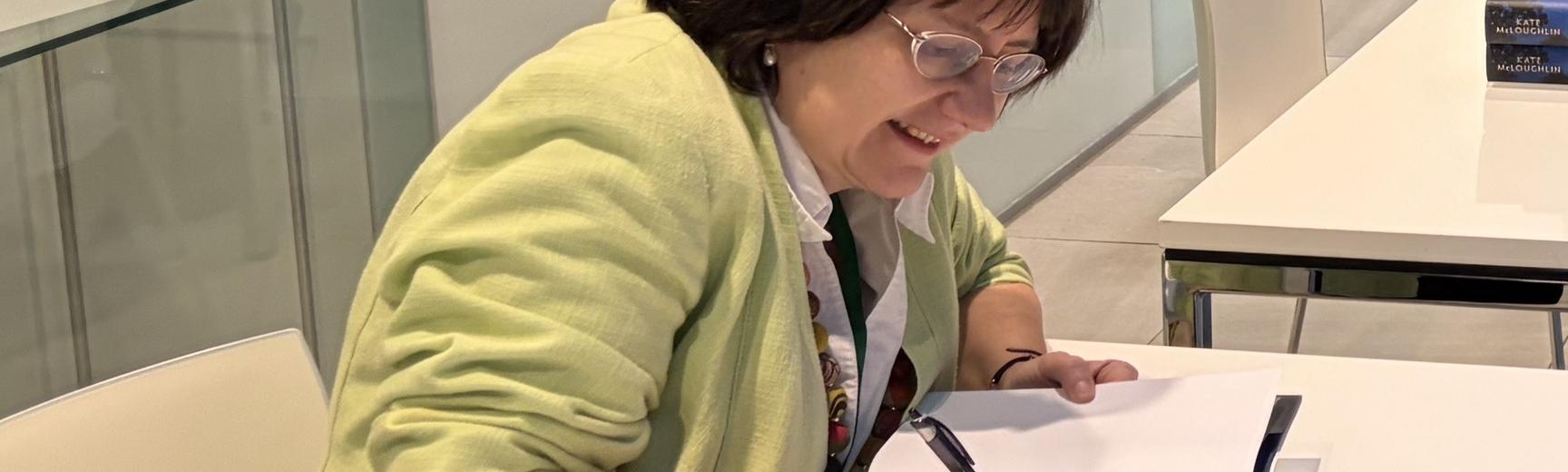 Kate McLoughlin signing book