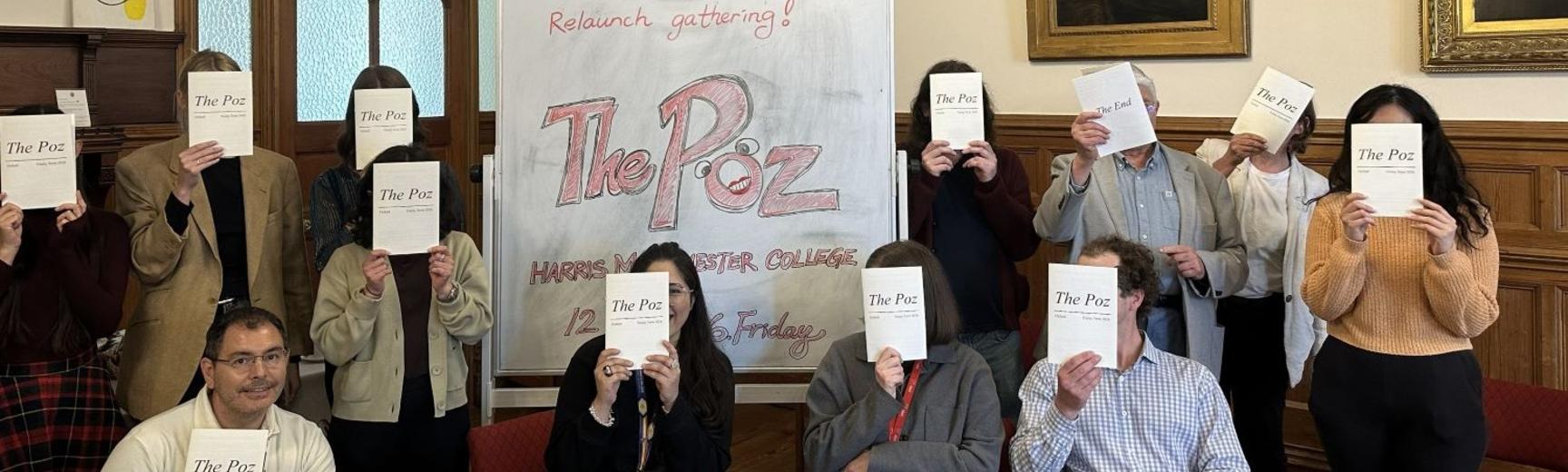 People hide their faces behind a magazine