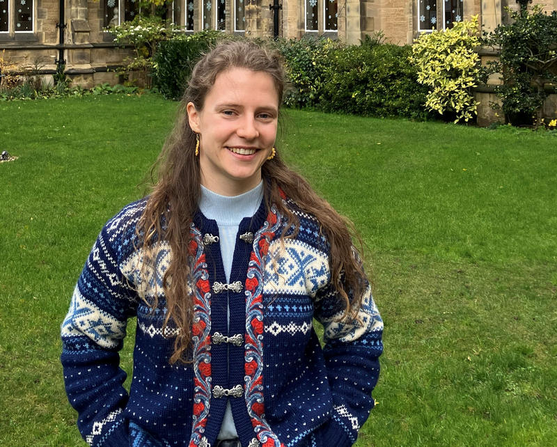 An image of a young woman in a college garden