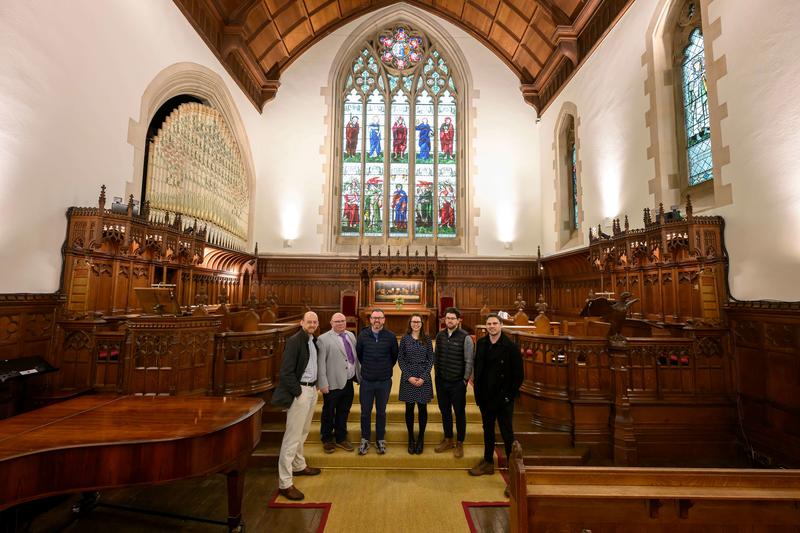 A group of people standing in the HMC Chapel