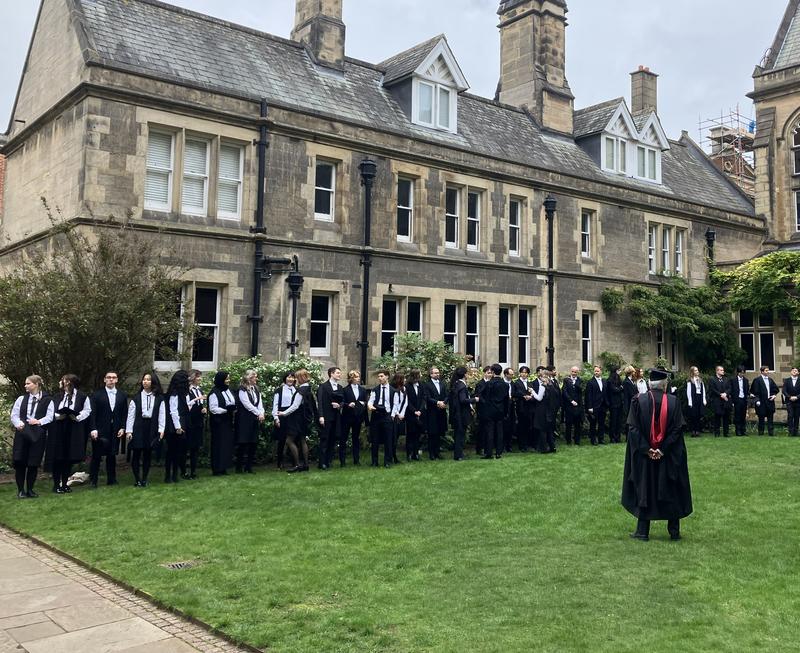 Students in gowns in a college quad