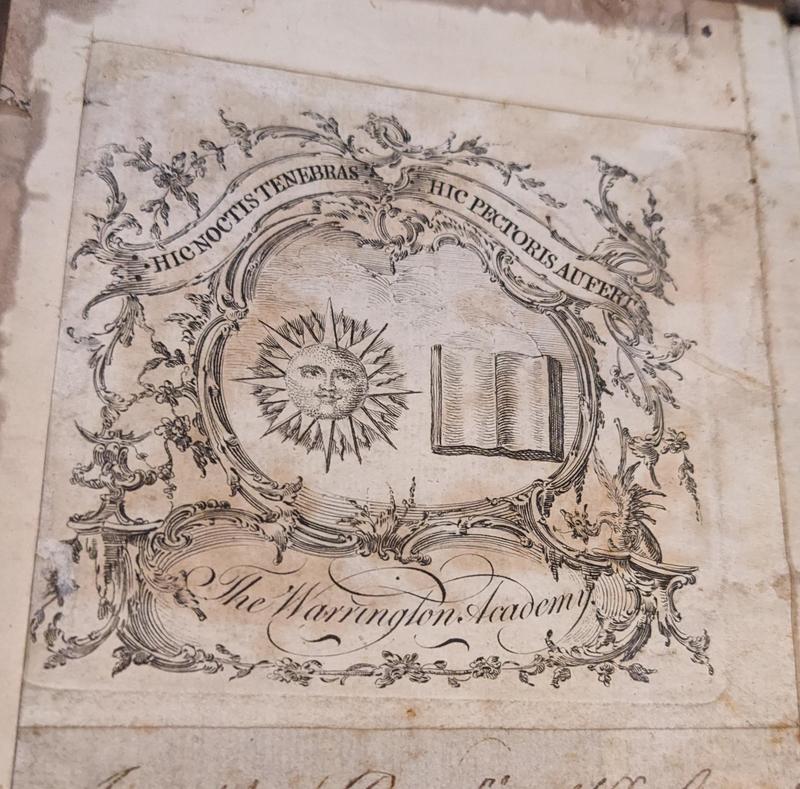 An elaborate bookplate with a sun and book included in a complex design