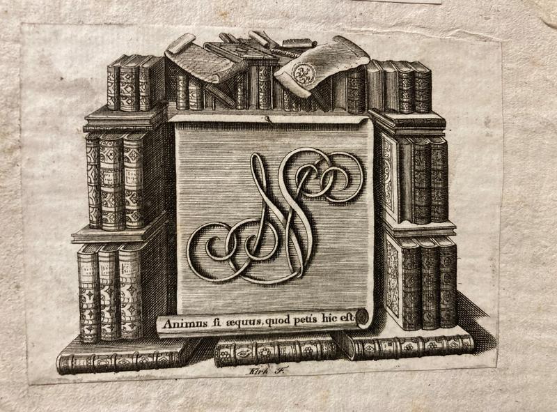An etched image with initials shown surrounded by stacked books