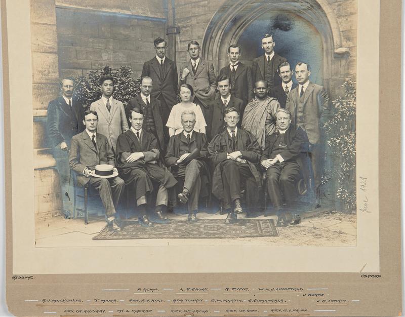 A black and white college photo dated june 1921 showing a group of mostly male students formally posing for the picture. 