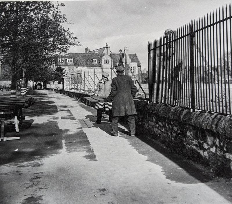 Railings jw Two men moving a large metal railing from a wall
