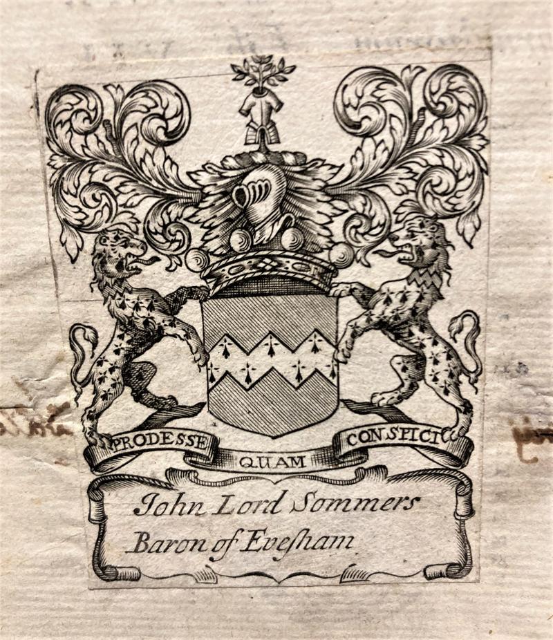 An etched image of a shield and armorial beasts on a bookplate