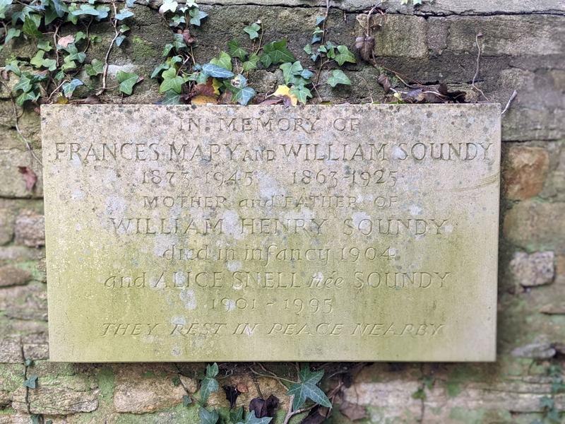 A picture of a memorial stone attached to the wall, with Soundy members listed on it.