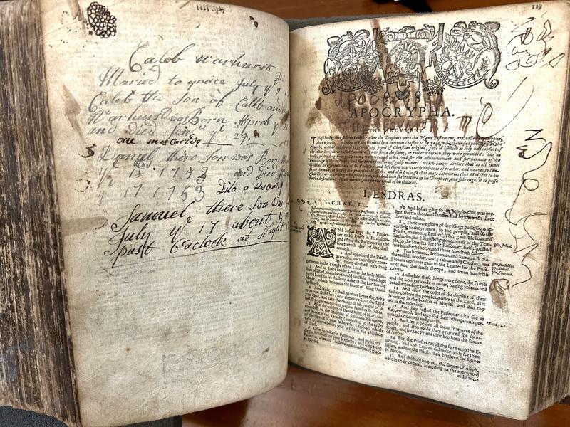 X15904 detail An open double page with handwriting, some in a child's hand, scribbled over the pages