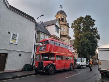 A vintage double-decker bus outside Harris Manchester College