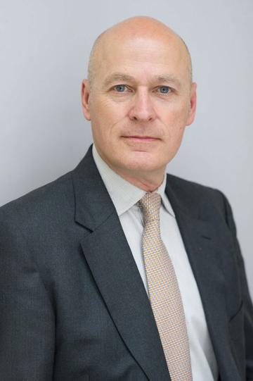 Headshot of a man in a suit with tie