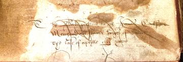 A detail of a handwritten inscription in elaborate hand 