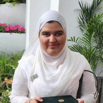 Student Khansa Maria with her Medal of Excellence