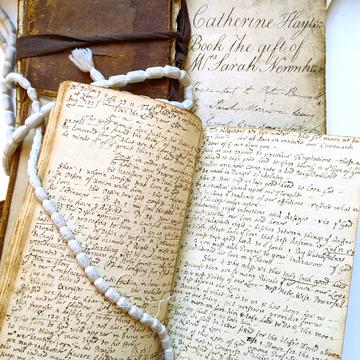 A group of handwritten notebooks stacked on each other