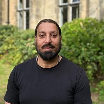 Headshot of Qaisar Shujaa
