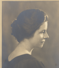 A black and white photograph of Margaret Crook in profile, showing her shoulders and head.  