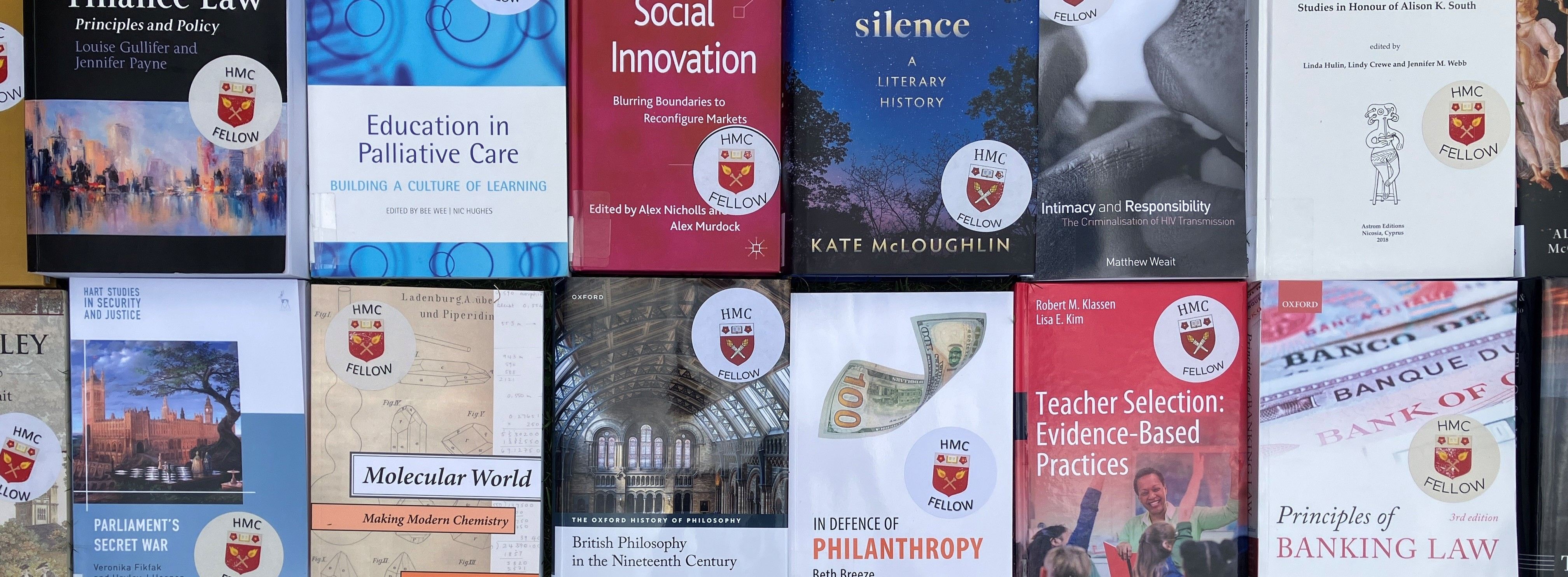Books by fellows laid out in rows