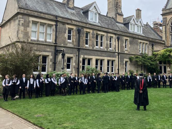 Students in gowns in a college quad