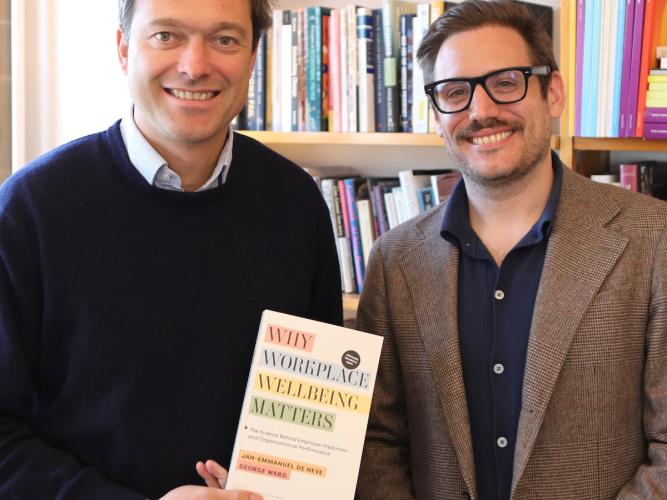 Professor de Neve and Dr Ward holding their book