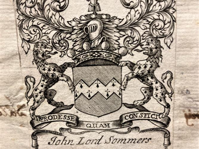 An etched image of a shield and armorial beasts on a bookplate