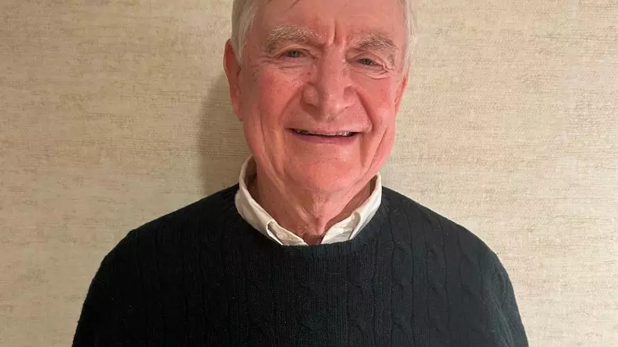 Headshot of a man in a green sweater