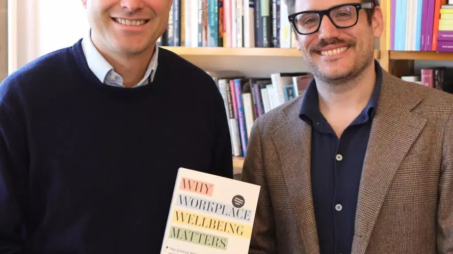 Professor de Neve and Dr Ward holding their book