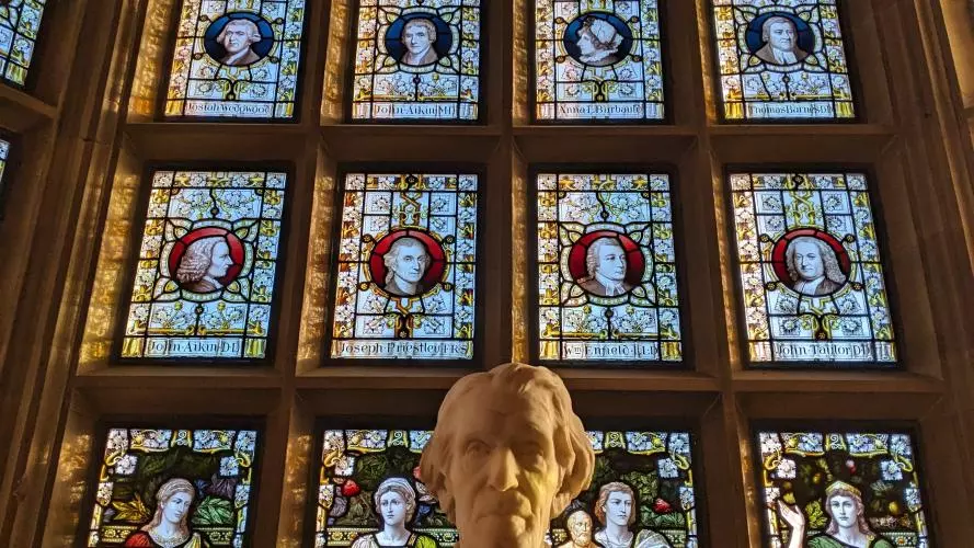 A picture of the Warrington Windows with the martineau statue in the foreground