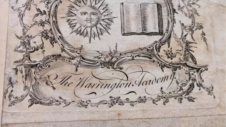 A black and white etching of a bookplate from Warrington Academy featuring a sun and open book