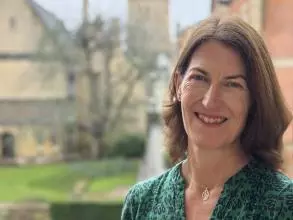 Professor Beth Breeze with background of Harris Manchester College