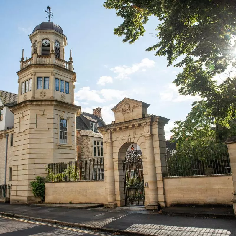 Landscape image portraying a clocktower, entrance to the College and buildings