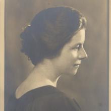 Black and white photograph of a female.  Head and shoulders. 