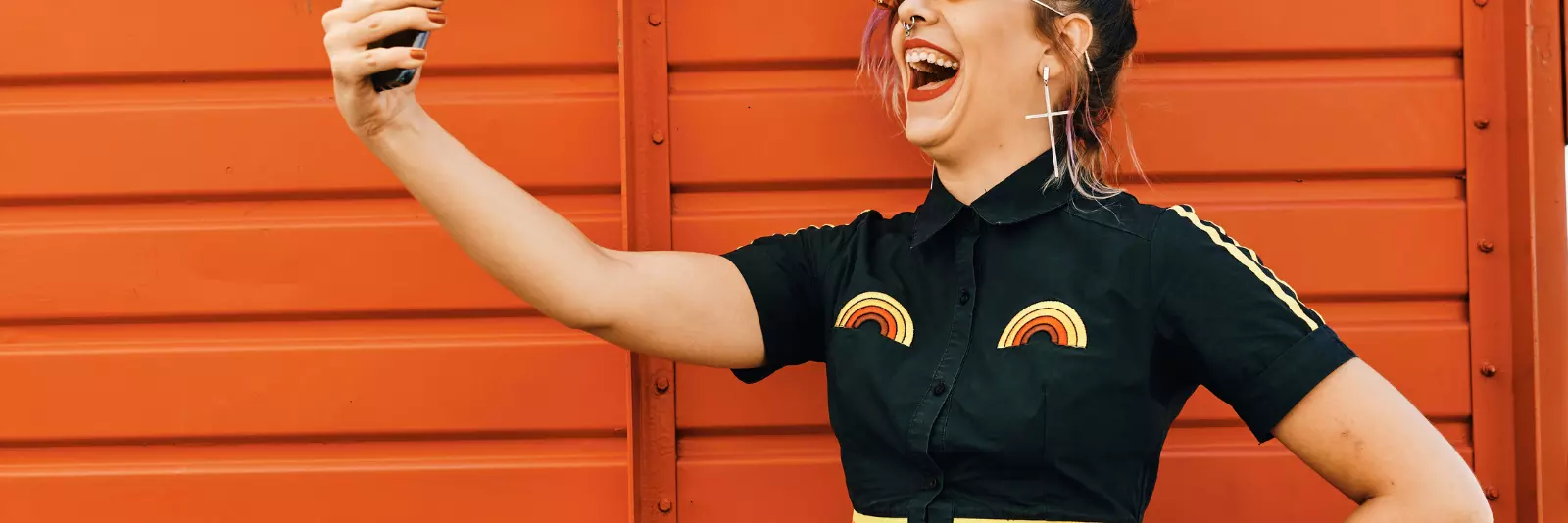 Woman holding phone in the air