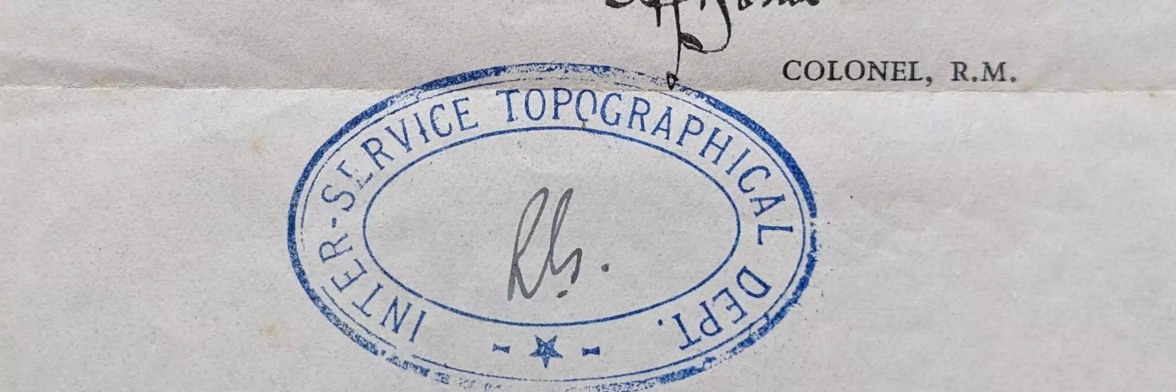 A blue stamp with the words Inter-Service Topographical Dept printed in blue